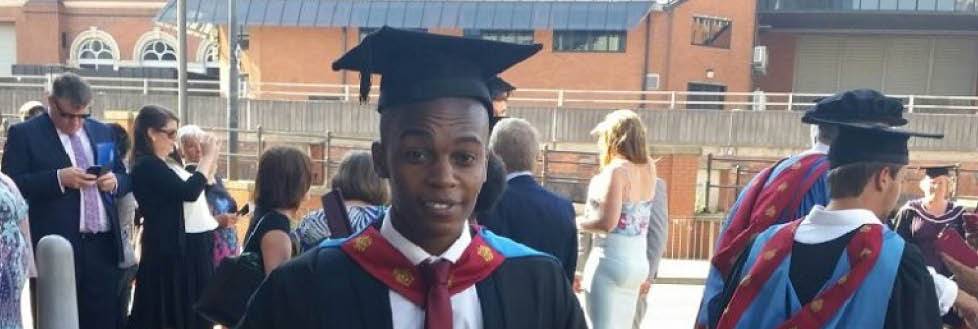 Student in cap and gown outside graduation ceremony